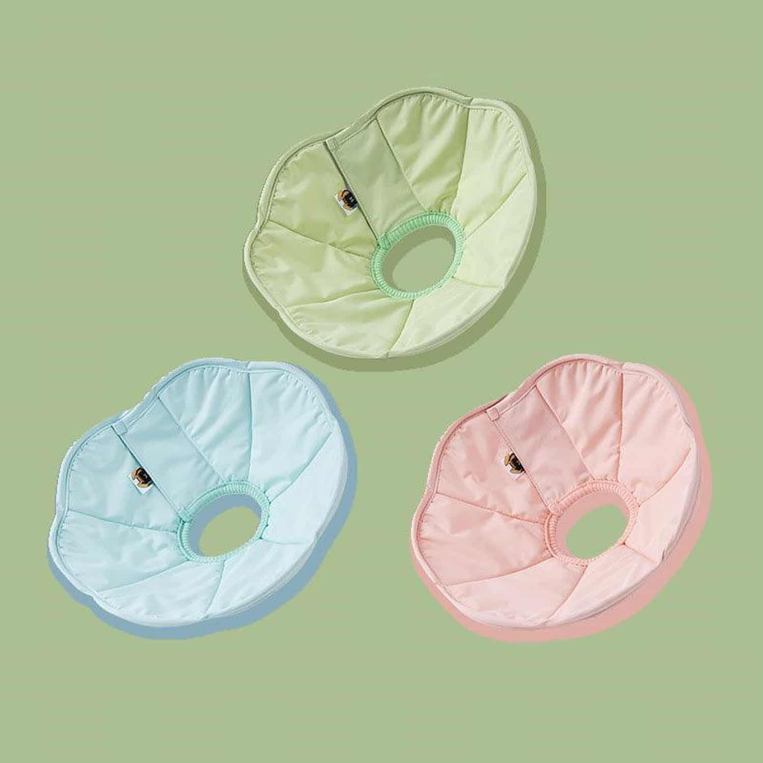 Soft polyester cat recovery cone in mint blue, worn by white longhair cat, showing wide border and flexible shape