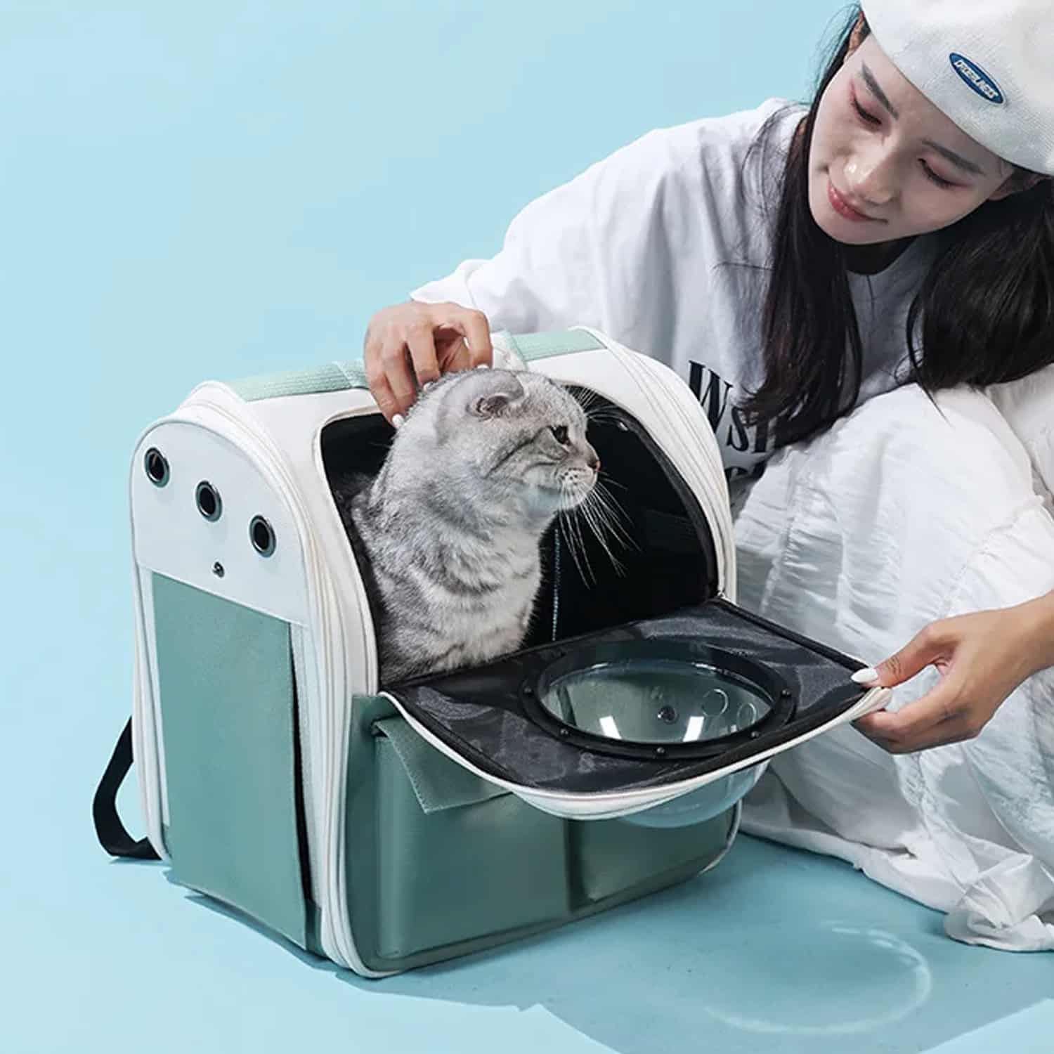 Structured space capsule pet backpack with bubble window and front storage pockets, worn on back