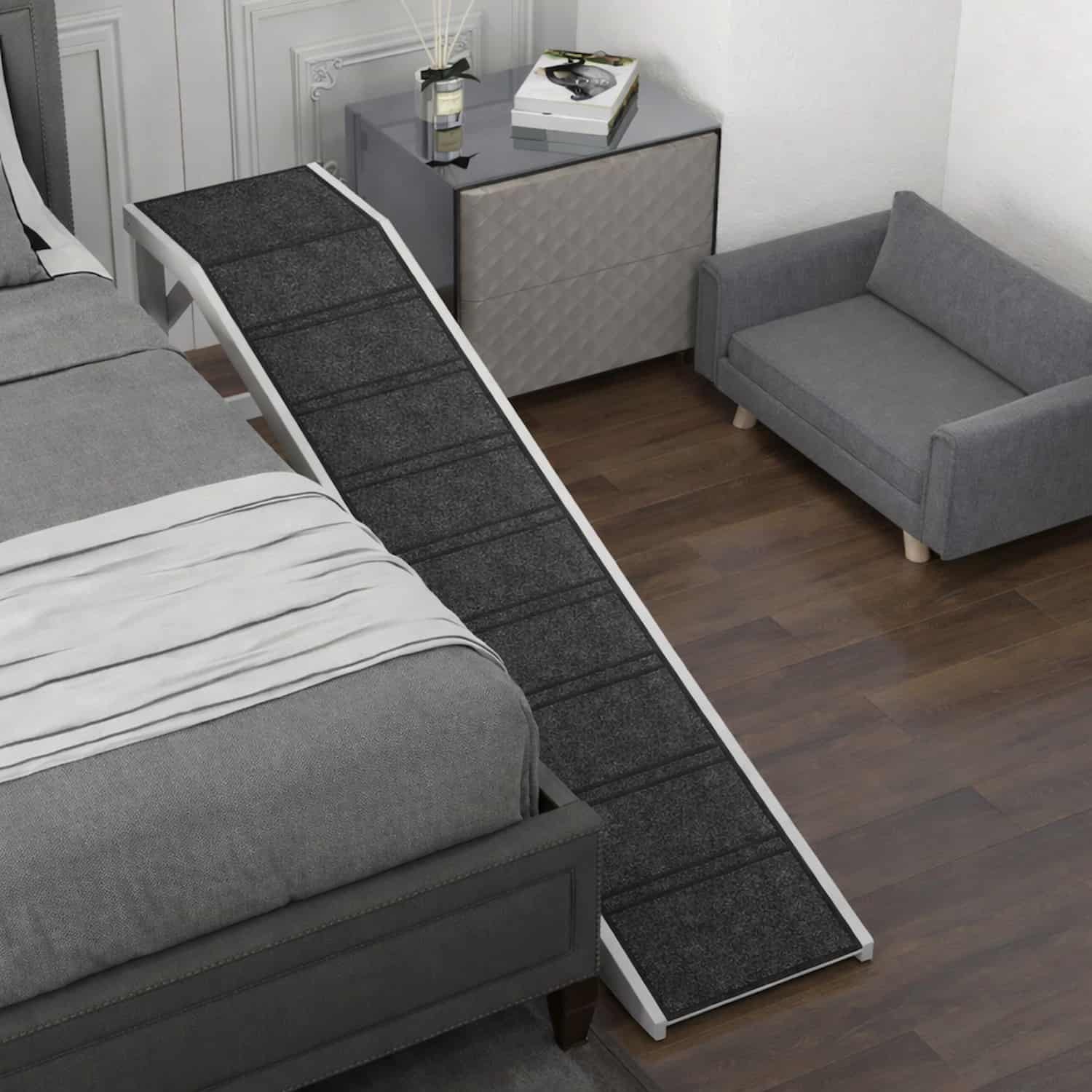 White wooden pet ramp with black carpeted surface