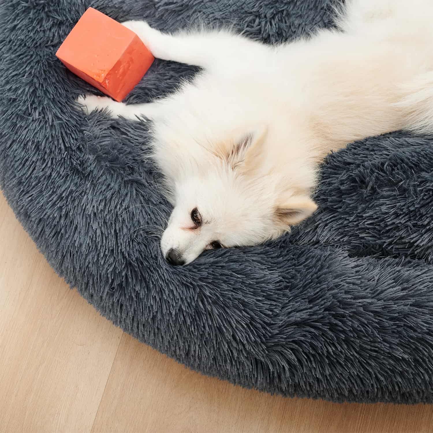 Fluffy donut pet bed with raised plush rim for neck support, PP cotton fill, anti-slip Oxford base, available in three sizes for dogs and cats up to 77 lbs